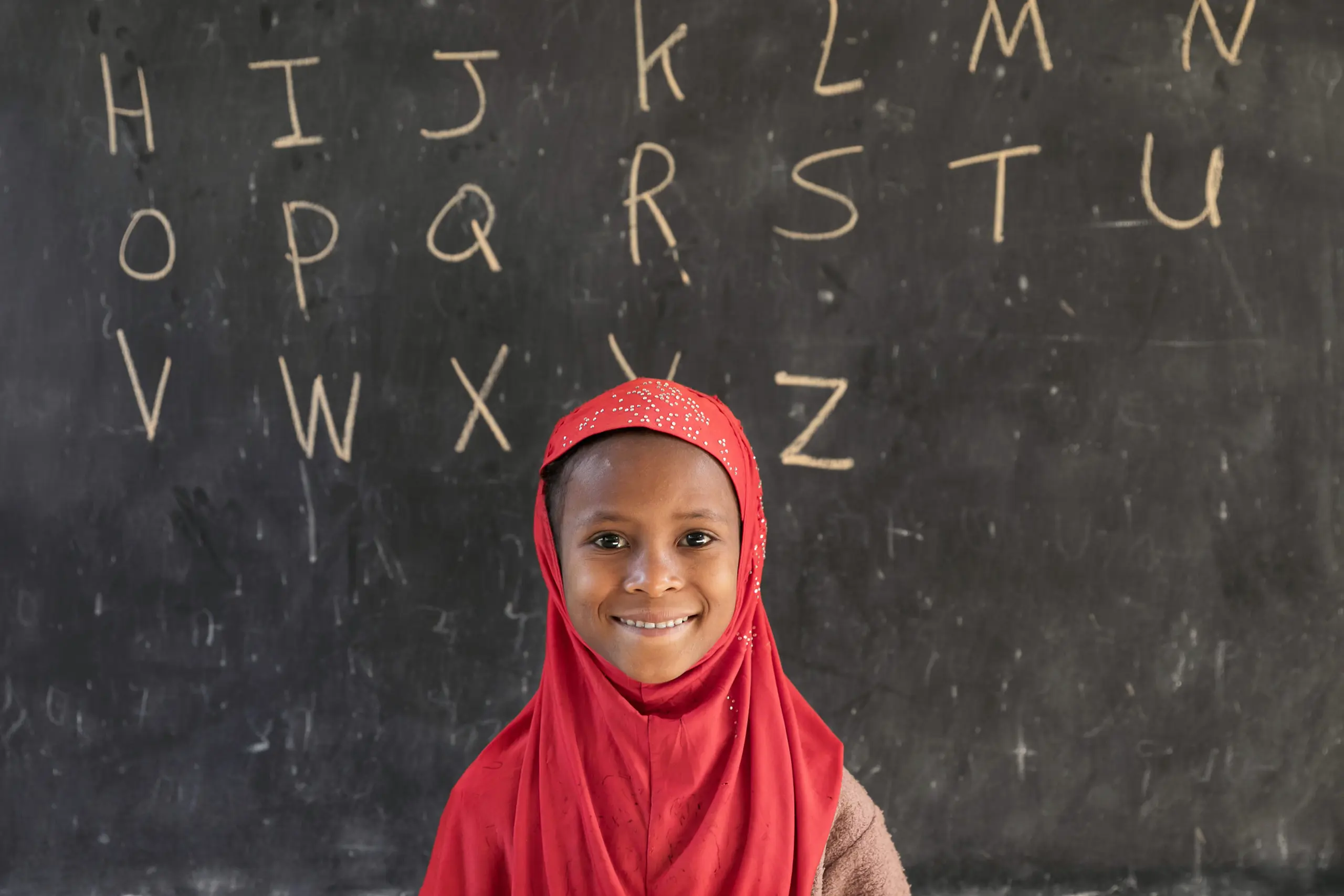 A first grade student at the blackboard; Ethiopia.