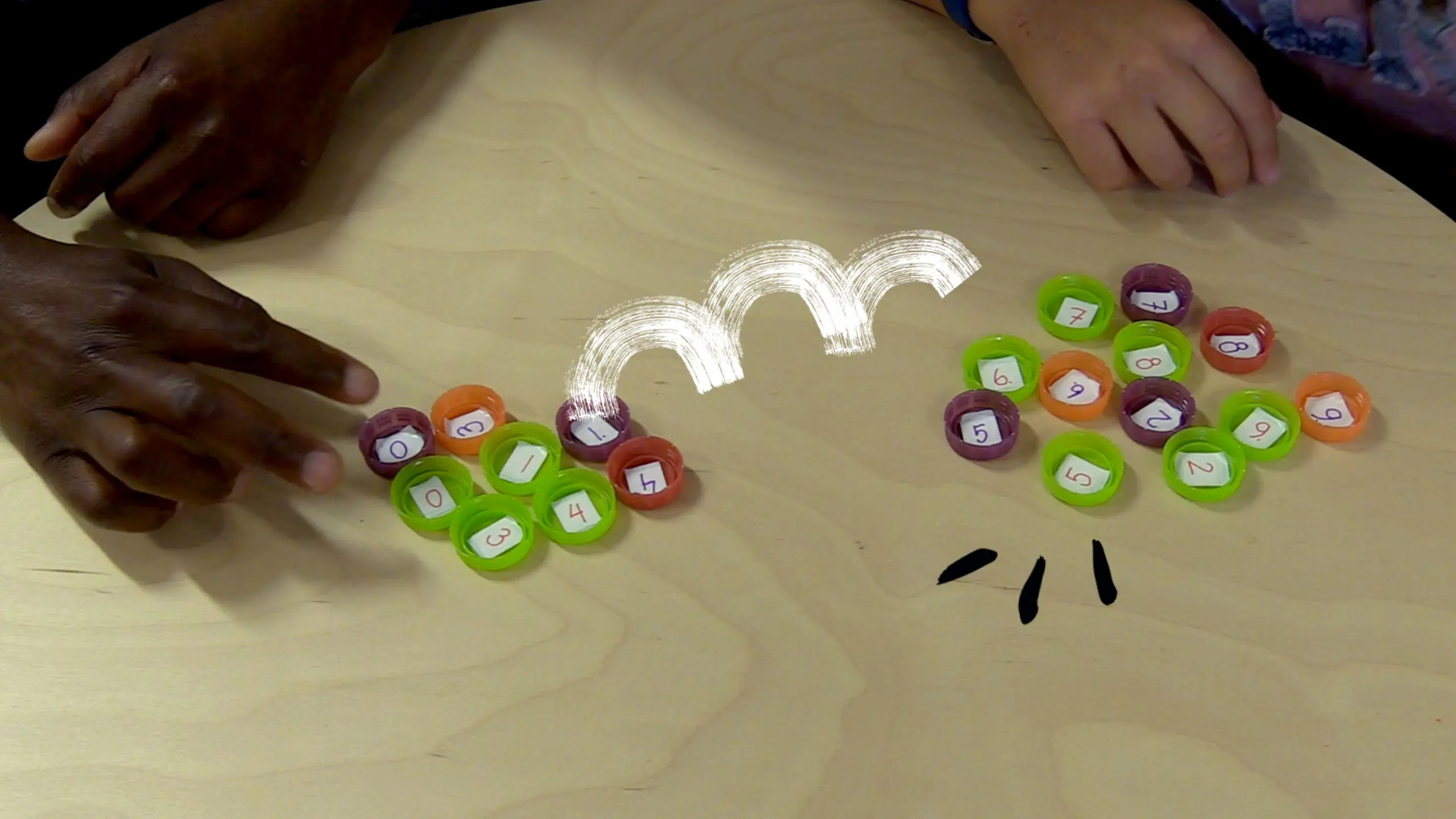 Bottle caps on the table with number in each of them