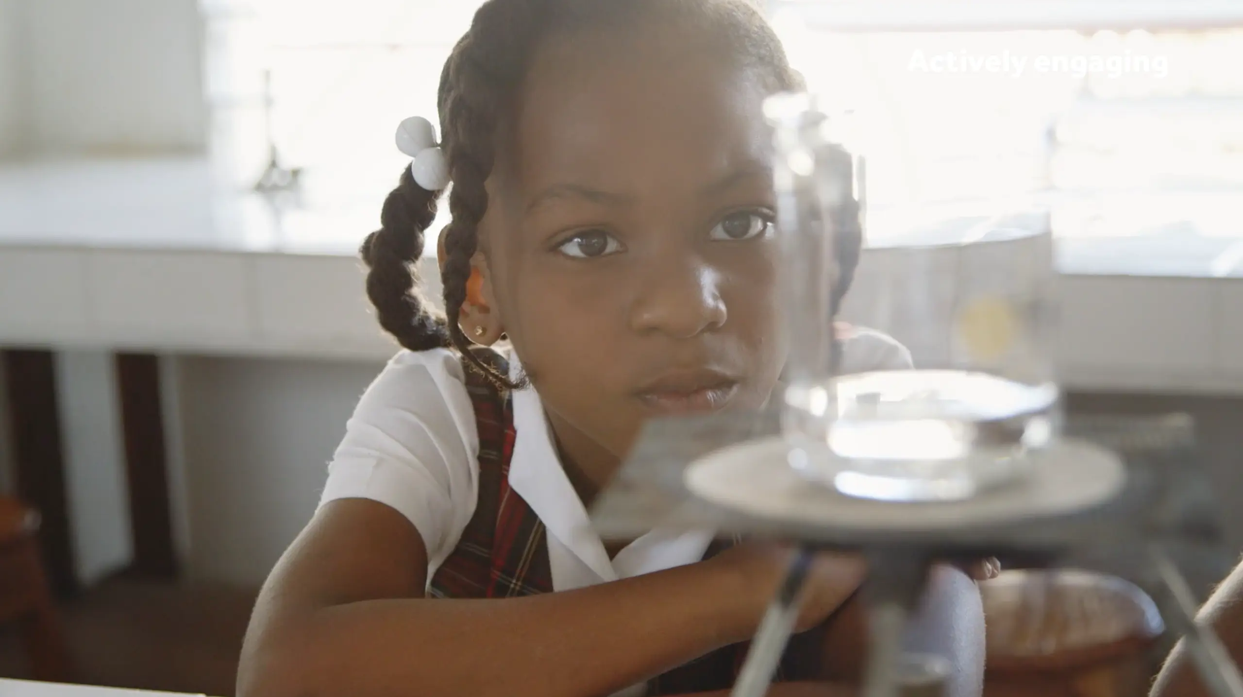 Girl looking at a glas with experiment