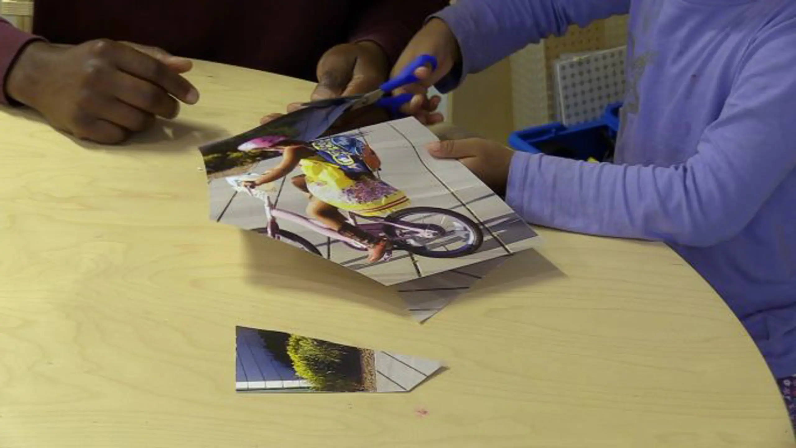 Child cutting picture with scissors